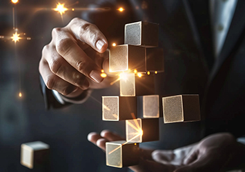 Close up of hands arranging floating wooden blocks with sparks of light